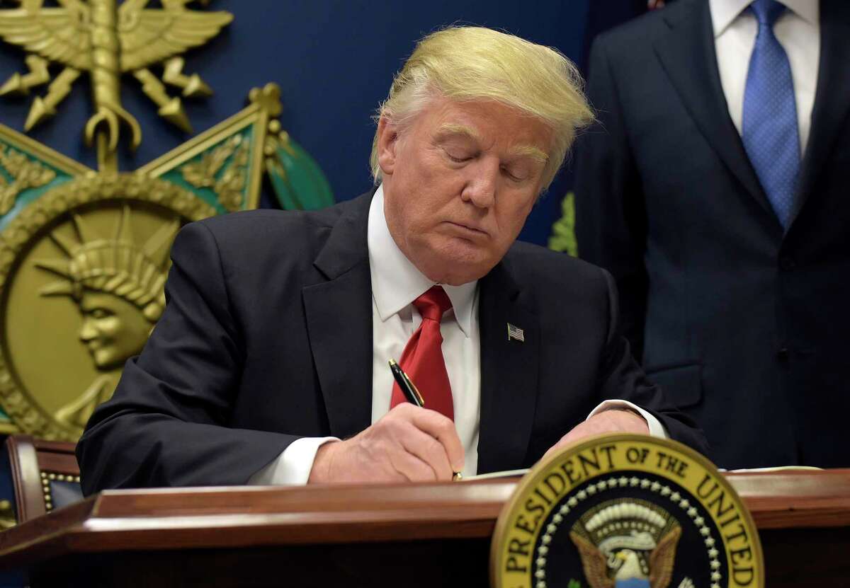 President Donald Trump signs an executive order on extreme vetting during an event at the Pentagon in Washington, Friday, Jan. 27, 2017. 