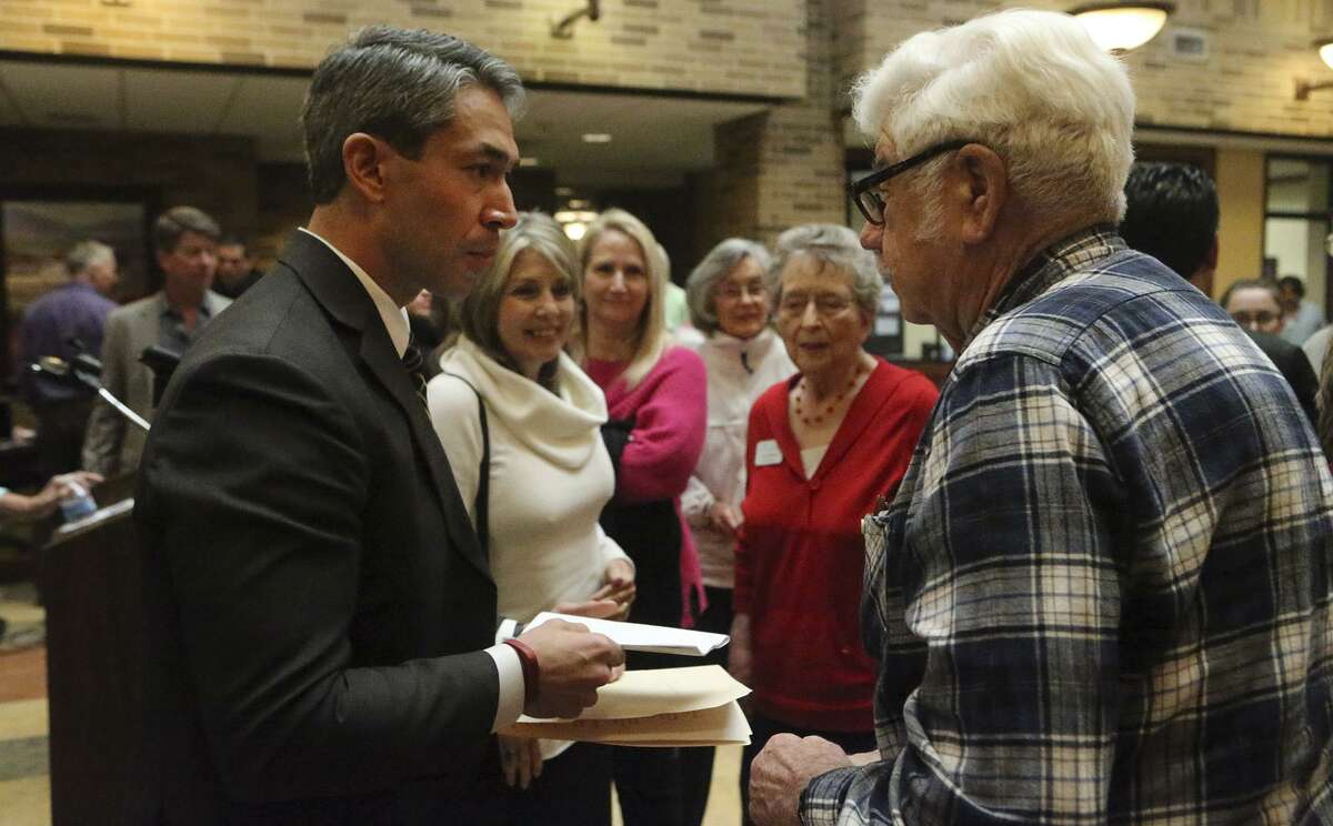 District 8 Councilman Ron Nirenberg (left) talks with Fred Wendt (right) during a mayoral forum held Fridayat Morningside Ministries at the Meadows.