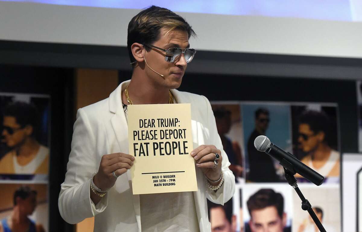 Milo Yiannopoulos holds a sign as he speaks at the University of Colorado campus in Boulder, Colo., Wednesday, Jan. 25, 2017. 