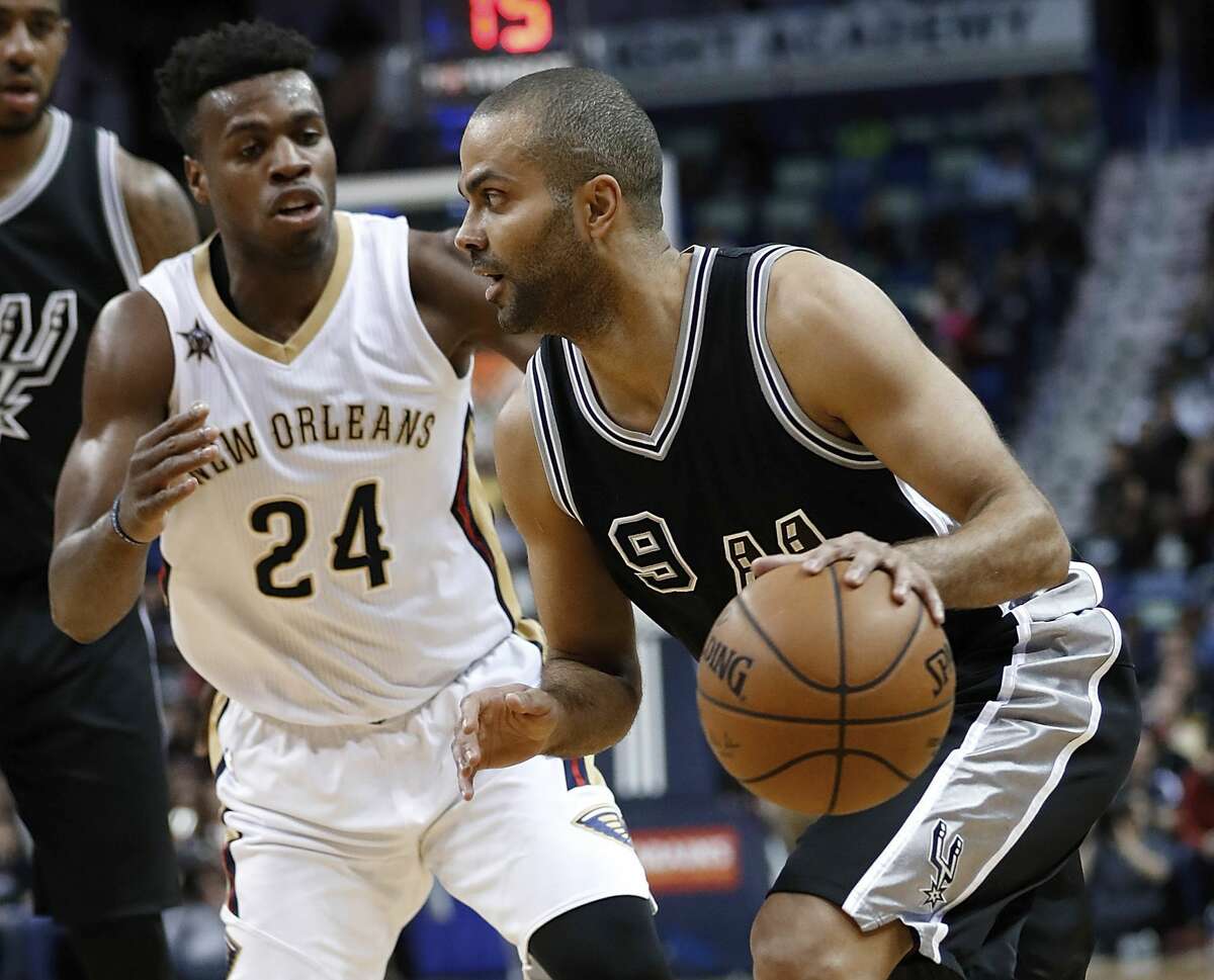 San Antonio Spurs guard Tony Parker (9) drives past New Orleans Pelicans guard Buddy Hield (24) during the first half of an NBA basketball game in New Orleans, Friday, Jan. 27, 2017. (AP Photo/Tyler Kaufman)