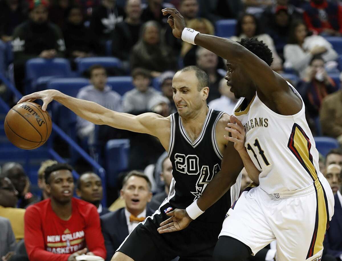 San Antonio Spurs guard Manu Ginobili (20) is guarded New Orleans Pelicans guard Jrue Holiday (11) during the first half of an NBA basketball game in New Orleans, Friday, Jan. 27, 2017. (AP Photo/Tyler Kaufman)