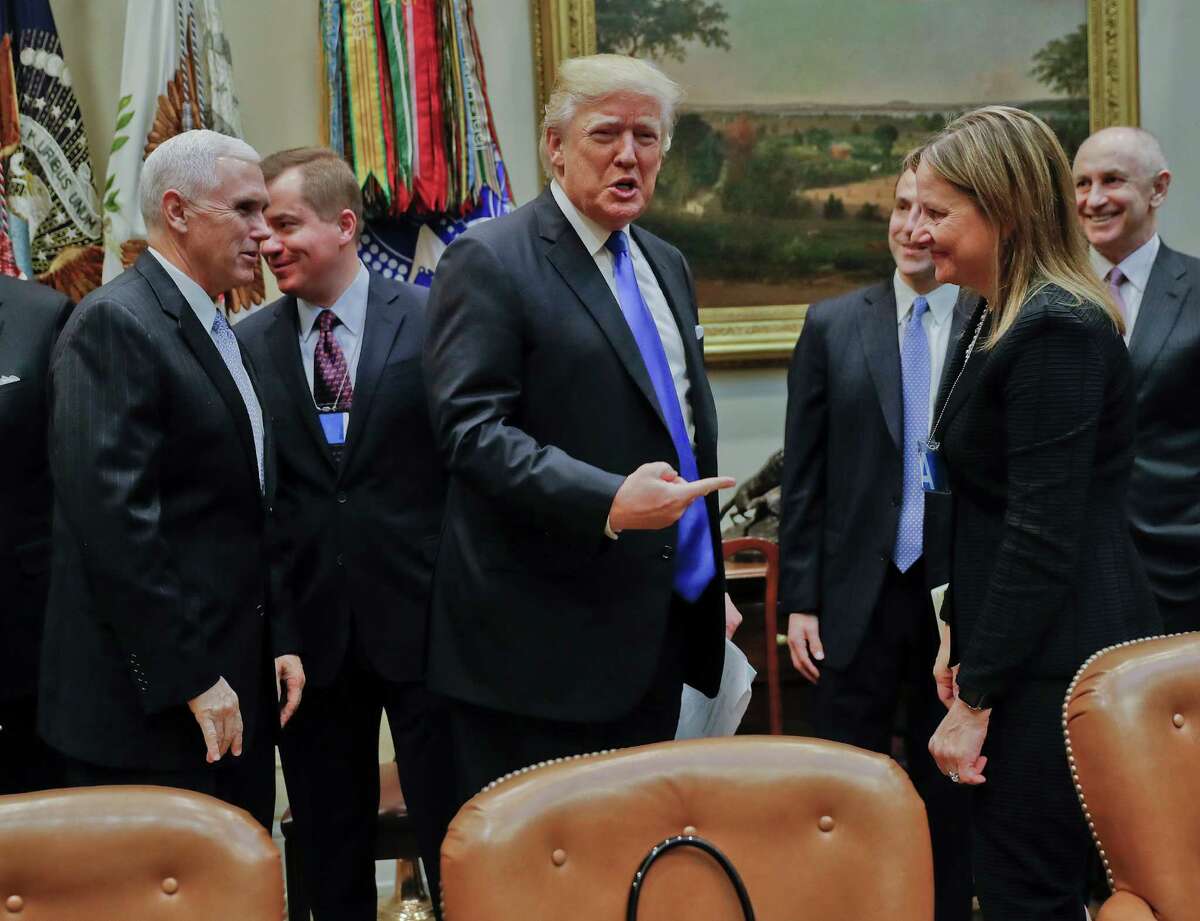 President Donald Trump gestures towards GM CEO Mary Barra, right, before the start of a meeting with automobile leaders in the Roosevelt Room of the White House in Washington, Tuesday, Jan. 24, 2017. From left are, Vice President Mike Pence, left, and Matt Blunt, president of the American Automotive Policy Council and the former governor of Missouri. (AP Photo/Pablo Martinez Monsivais)