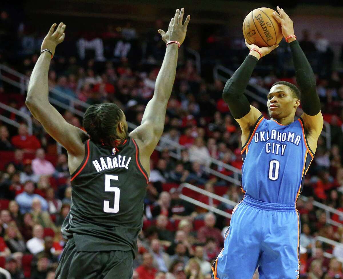 Oklahoma City Thunder guard Russell Westbrook (0) takes a three-point shot as Houston Rockets forward Montrezl Harrell (5) tries to block it during the fourth quarter of an NBA game at the Toyota Center, Thursday, Jan. 5, 2017, in Houston.