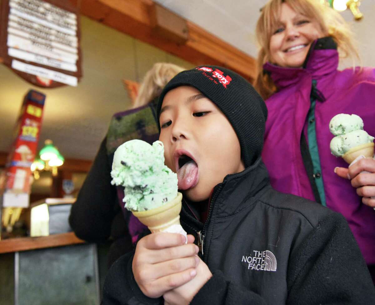 Seven-year-old Brendan Matias of Clifton Park and his mother Cynthia Matias with ice cream cones as Toll Gate Ice Cream gives away free ice cream as a thank you for their support of the its ailing owner Rob Zautner, Saturday Jan. 28, 2017 in Slingerlands, NY. Family members remind the public that their closing will only by temporary. (John Carl D'Annibale / Times Union)