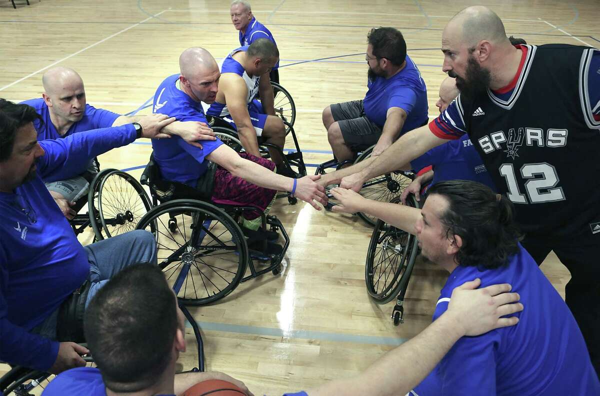 Members of one of the basketball teams playing an exhibition game huddle before the start of a game at the Air Force Wounded Warrior Program Warrior Care Event at Joint Base San Antonio-Randolph on Friday, Jan. 13, 2017. The CARE event provides seriously wounded, ill and injured military members, veterans and their caregivers focused and personalized service through caregiver support, training, adaptive and rehabilitative sports events.