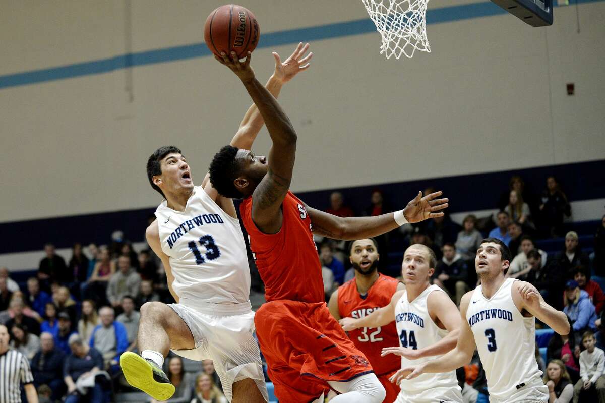 Saginaw Valley State's C.J. Turnage shoots as Northwood's David Jelinek defends during the first half on Saturday at Riepma Arena on the NU campus. Northwood won 64-63.