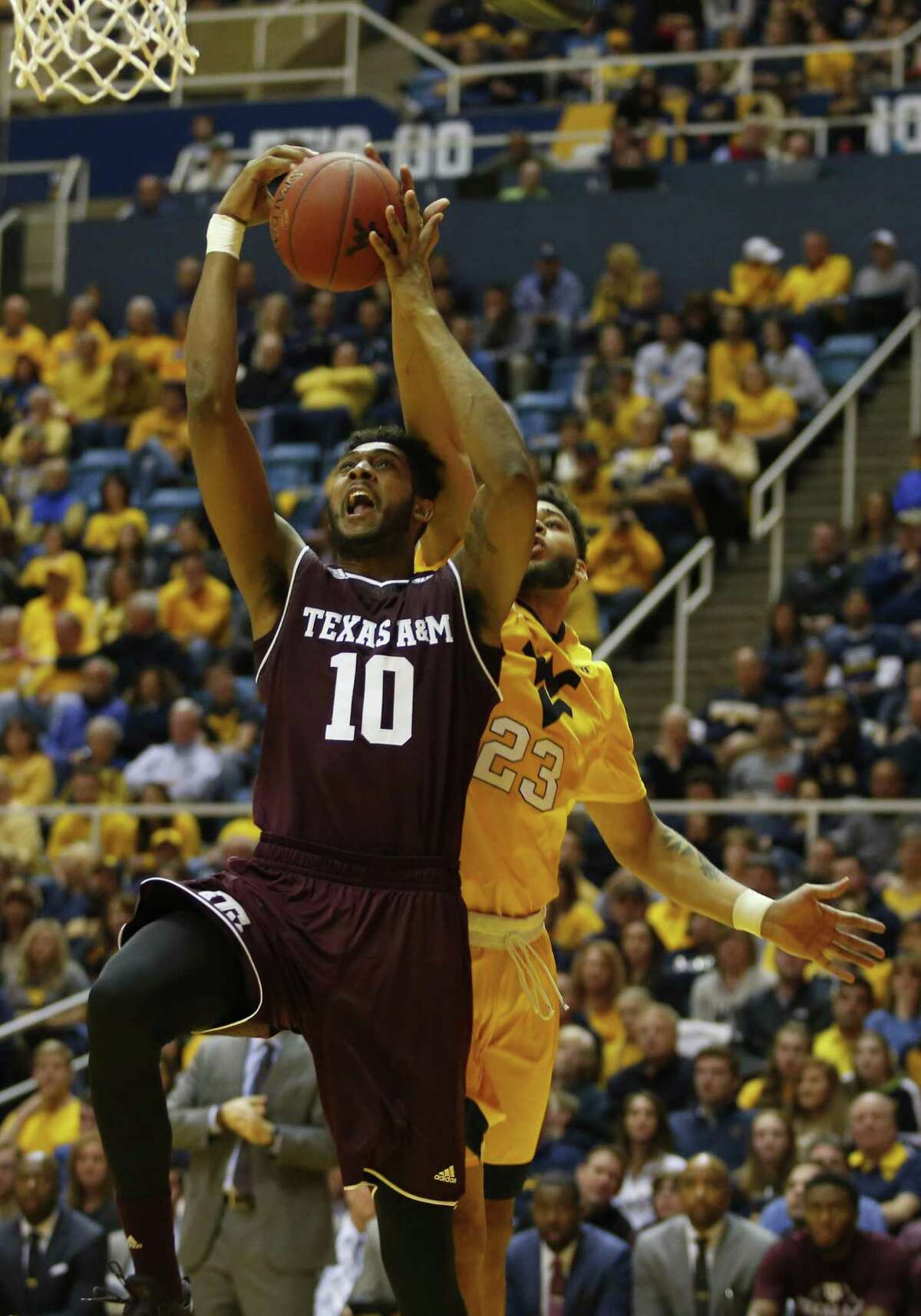 MORGANTOWN, WV - JANUARY 28: Tonny Trocha-Morelos #10 of the Texas A&M Aggies drives to the hoop against Esa Ahmad #23 of the West Virginia Mountaineers at the WVU Coliseum on January 28, 2017 in Morgantown, West Virginia. (Photo by Justin K. Aller/Getty Images)