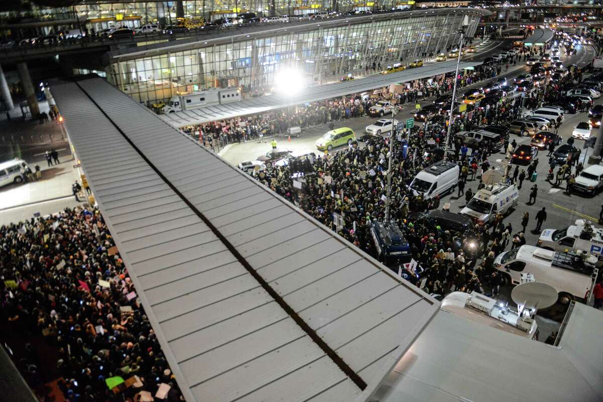 Protesters at New York's Kennedy Airport demonstrate against the new immigration ban on Saturday.