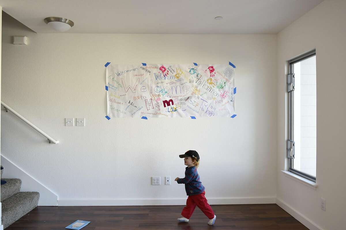 Keegan Longaway, 2, runs past a welcome banner, in his family's new condo, following a Habitat Terrace Home Dedication ceremony held by Habitat for Humanity of Greater San Francisco where they and 10 other families receive the keys to their new homes, in San Francisco, CA on Saturday, January 28, 2017.