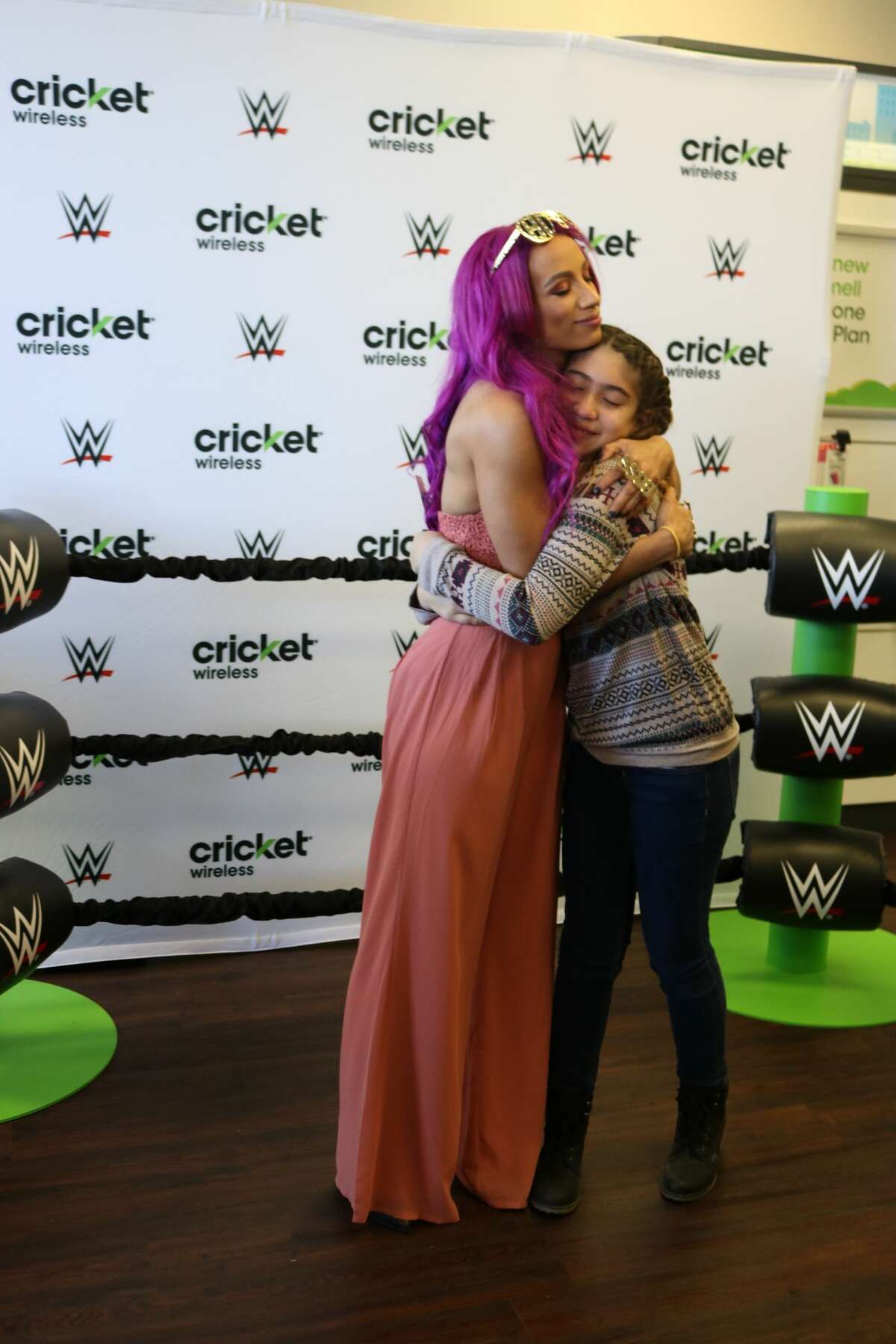 WWE superstar Sasha Banks presents tickets to the Royal Rumble to Zoe Robalino. Robalino was at a promotional event to meet banks and was randomly selected to win tickets to the WWE event at the Alamodome Sunday night.