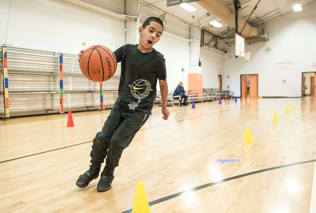 David Robles, 8, runs the course made for the Jr. NBA Skills Challenge on Saturday at the Hillside Recreational Center.