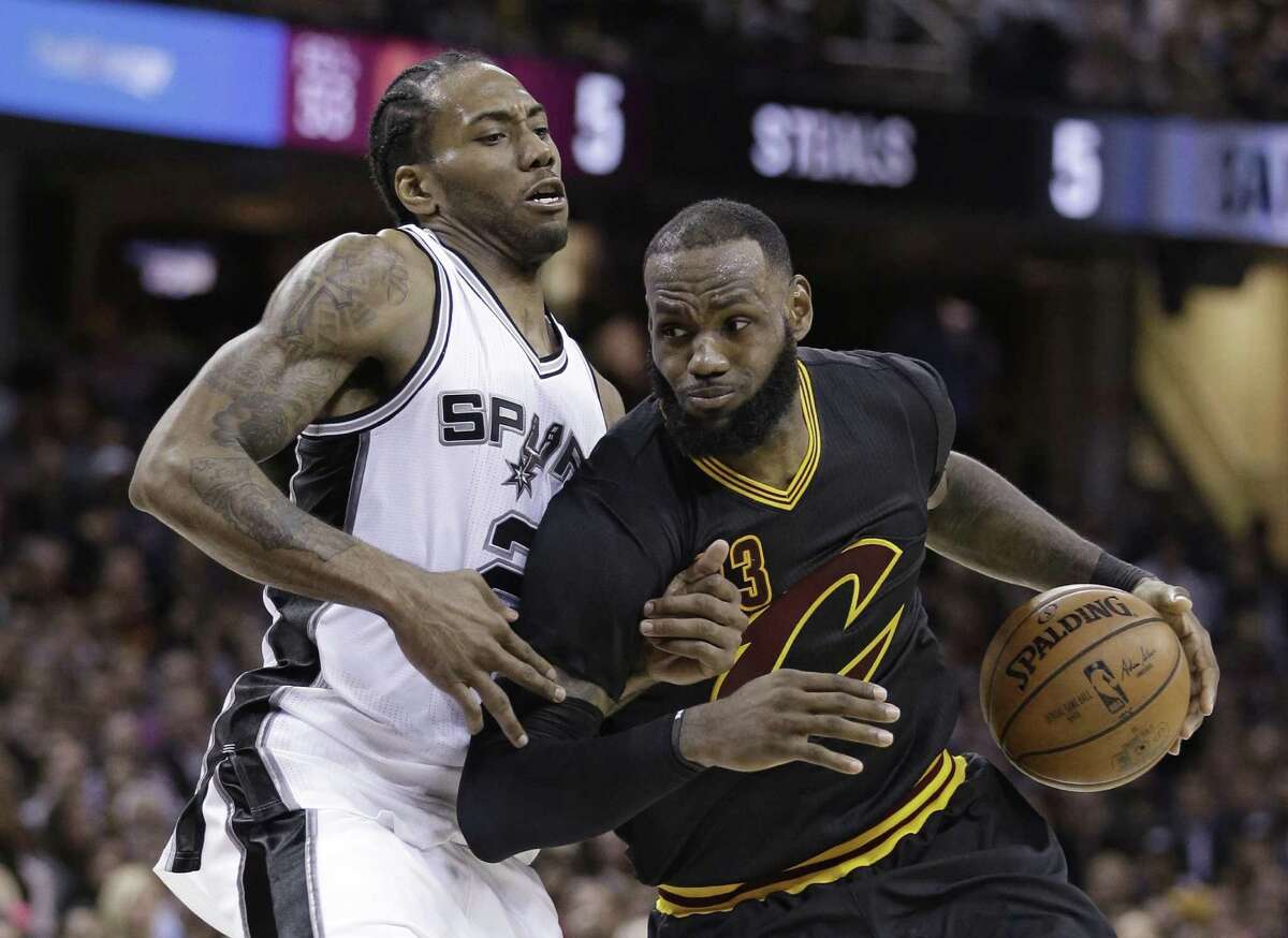 Cavaliers’ LeBron James drives against the Spurs’ Kawhi Leonard during the second half on Jan. 21, 2017, in Cleveland.