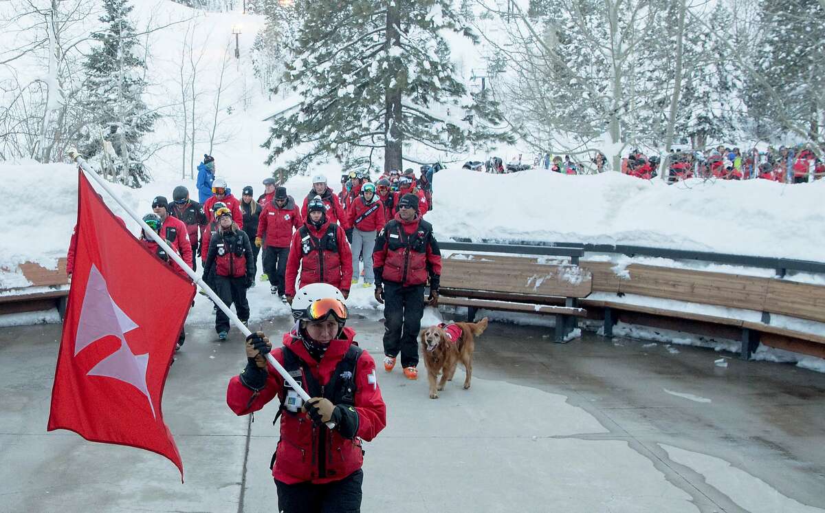 Ski Patrolmen from around the country arrive at a memorial after skiing down a mountain at Squaw Ski Resort in North Lake Tahoe, California on January 27, 2017. On Tuesday, Joe Zuiches, a ski safety patroller, was killed from a hand-charge explosion during avalanche control activities at Squaw Valley ski resort, the third explosive-caused avalanche death in 43 years.