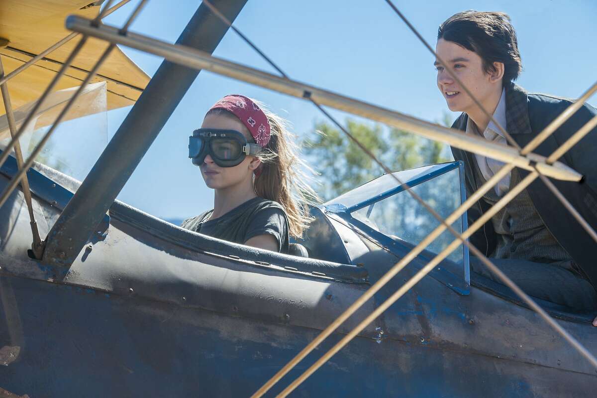This image released by STX Productions shows Britt Robertson, left, and Asa Butterfield in a scene from "The Space Between Us." (Jack English/STX Productions via AP)
