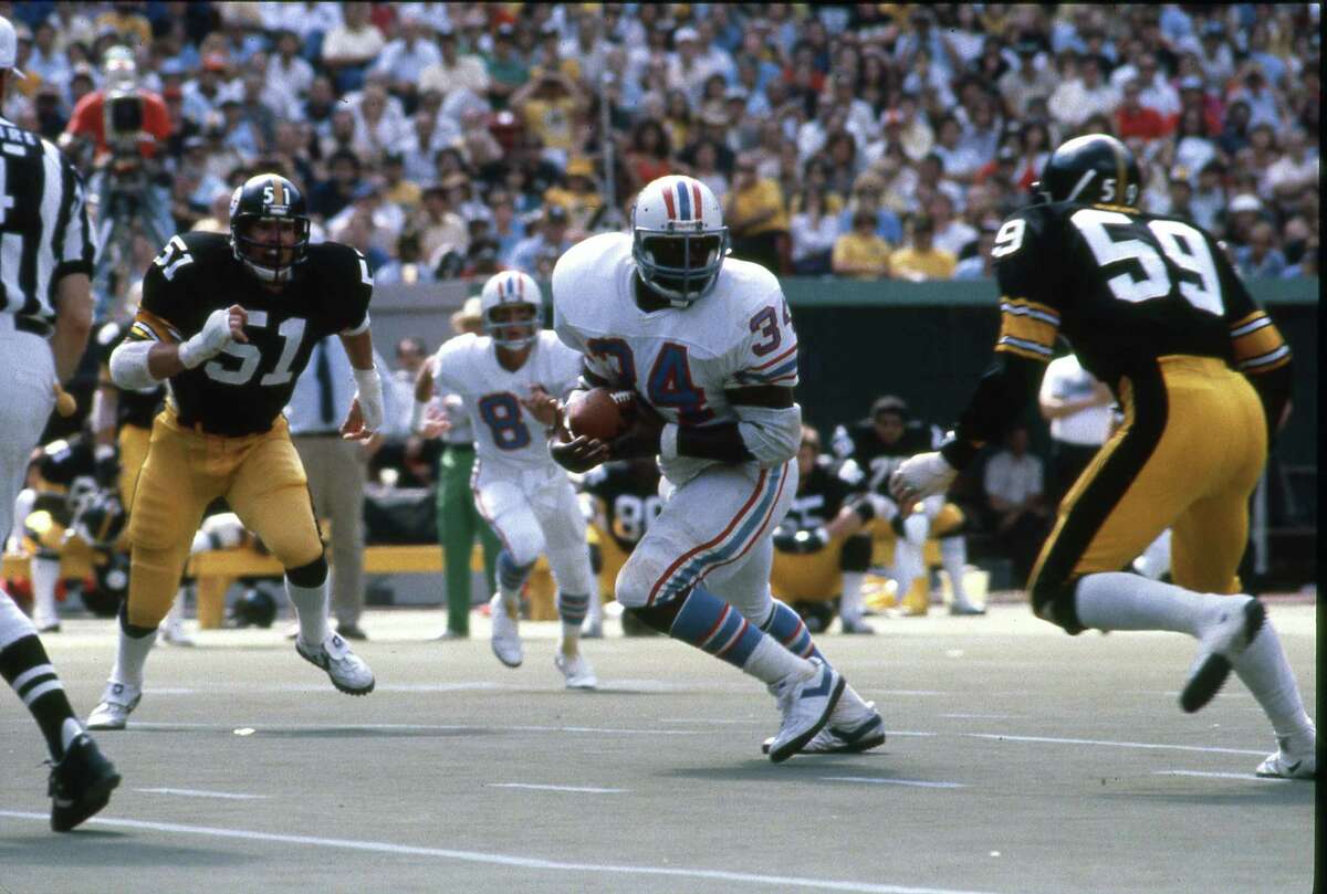 Pittsburgh Steelers Loren Toews (51) and Jack Ham (59) surround Houston Oilers running back Earl Campbell (34) at Three Rivers Stadium on Sept. 7, 1980.