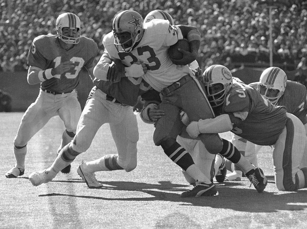 Dallas running back Duane Thomas is stopped by Miami tacklers after picking up a short gain during the Super Bowl game in New Orleans, Jan. 16, 1972. Miami tacklers are, from left, Doug Swift, Nick Buoniconti and Manny Fernandez. (AP Photo)