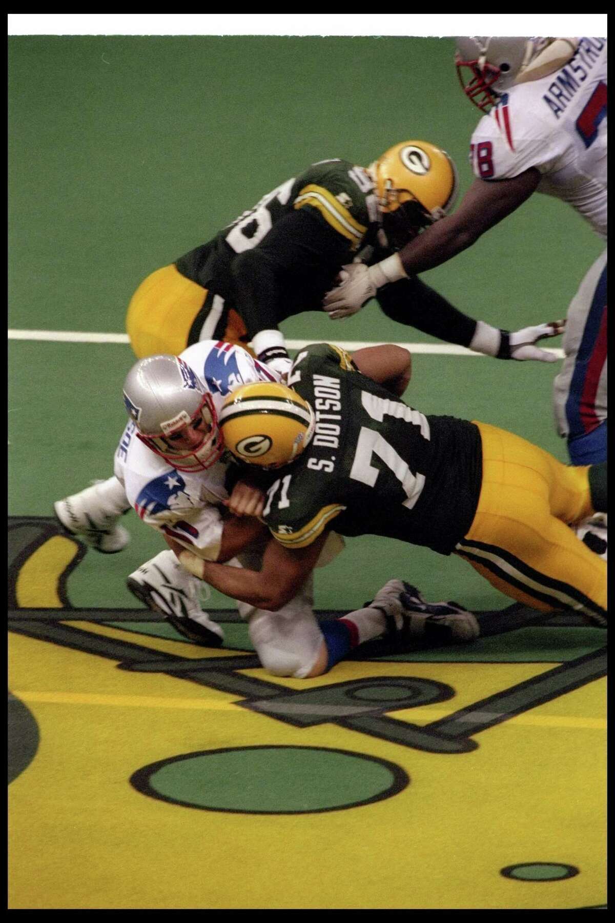 Packers lineman Santana Dotson sacks Patriots quarterback Drew Bledsoe in Green Bay's 35-21 victory in Super Bowl XXXI at the Superdome in New Orleans.