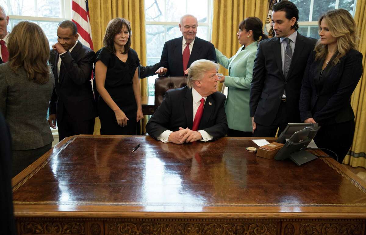President Donald Trump during the signing of an executive action to cut regulations for small businesses, while surrounded by small business leaders in the Oval Office of the White House in Washington, Jan. 30, 2017. (Stephen Crowley/The New York Times)