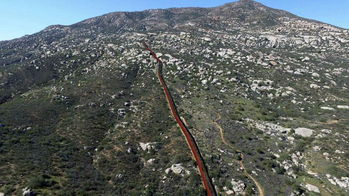 Aerial picture taken with a drone of the urban fencing on the border between the US and Mexico in Tecate, northwestern Mexico on Thursday. President Donald Trump’s plan for a border wall and a 20 percent tax on Mexican imports threatens to start a trade war.