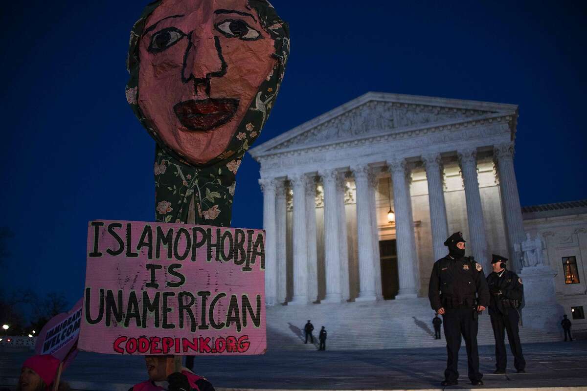 Demonstrators gather outside the US Supreme Court demanding US President Donald Trump reverse hateful anti-refugee and anti-immigration executive orders in Washington, DC, January 30, 2017. / AFP PHOTO / JIM WATSONJIM WATSON/AFP/Getty Images