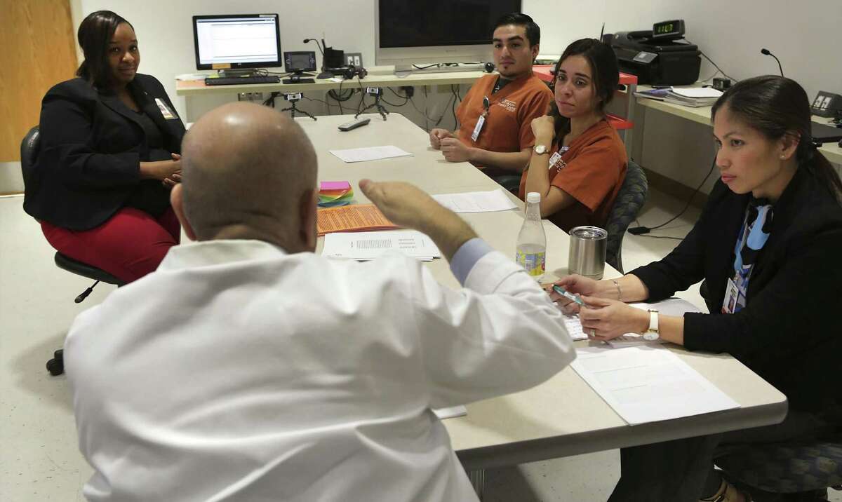 Nursing students Destiny Chavez-Levey and Esequiel Salcedo, center right, are questioned by Dr. Peter Guarnero, center left, during an undergraduate psychiatric simulation debriefing. Nursing students interview live "patients" posing as simulated psychiatric patients, and then are debriefed, at UTHSC Nursing School on Monday, Jan. 30, 2017. Elesha Roberts, left, and Sherry Megerle, right, both Clinical Assistant Profesors take part in the debriefing process.