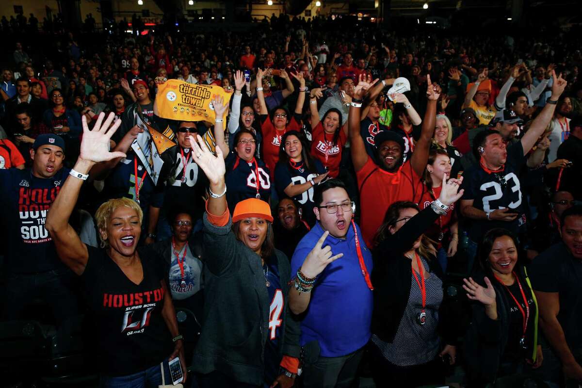 Fans cheer during Super Bowl LI Opening Night at Minute Maid Park Monday, Jan. 30, 2017 in Houston. The Houston Super Bowl Committee and Visit Houston expect about 140,000 out-of-town visitors for the big game. Click through the slideshow to see what Houston had to do in order to host the Super Bowl. 