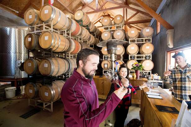 Maclain Atkinson tastes wine at Amador Cellars in Plymouth, Calif., on Saturday, Jan. 28, 2017. At right is winemaker Michael Long.