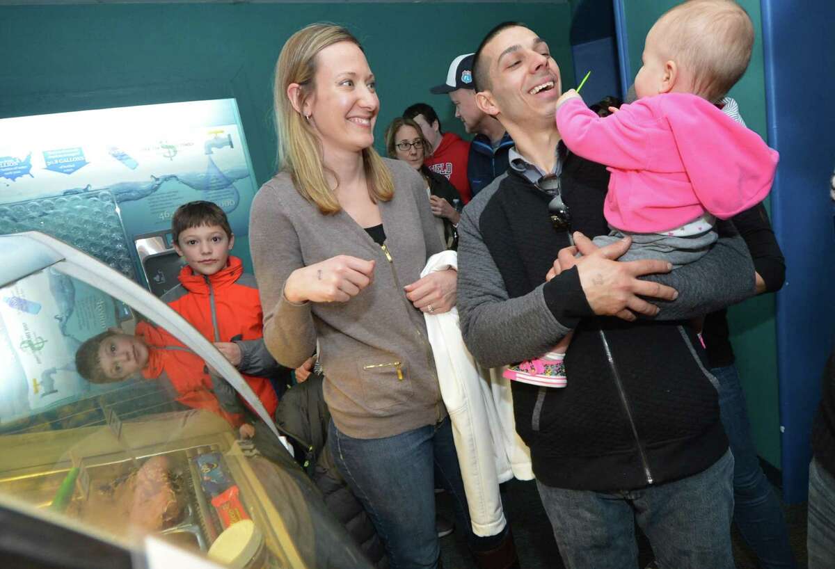 Bethel's Marco Rodriques gets a tase of gelato with wife Colleen and daughter Lianna at Screme Gelato Bar during Chocolate Expo on Sunday at The Maritime Aquarium in Norwalk Conn. About 40 local and regional vendors, including top area chocolatiers filled the Aquarium galleries, offering samples and sales of their gourmet chocolates, baked goods and specialty foods.