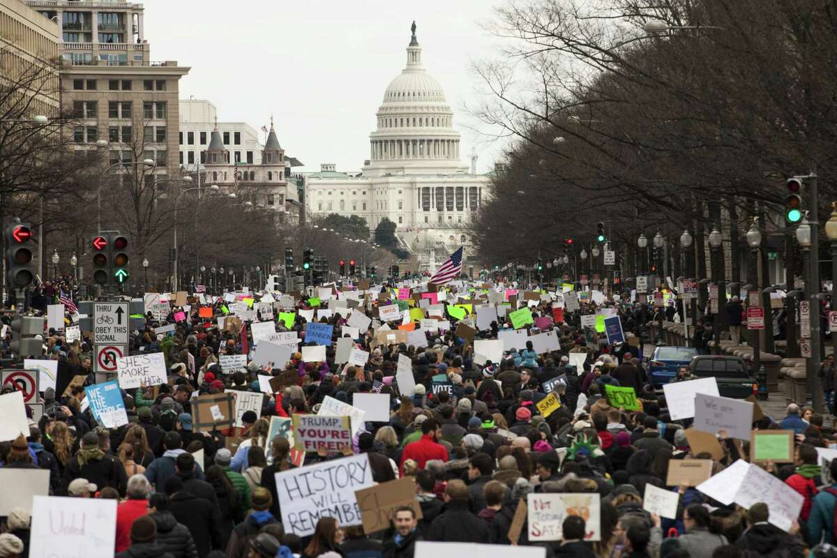 WASHINGTON, DC - JANUARY 29: Demonstrators march down Pennsylvania Avenue during a protest on January 29, 2017 in Washington, DC. Protestors in Washington and around the country gathered to protest President Donald Trump's executive order barring the citizens of Muslim-majority countries Iraq, Syria, Iran, Sudan, Libya, Somalia and Yemen from traveling to the United States. (Photo by Zach Gibson/Getty Images)