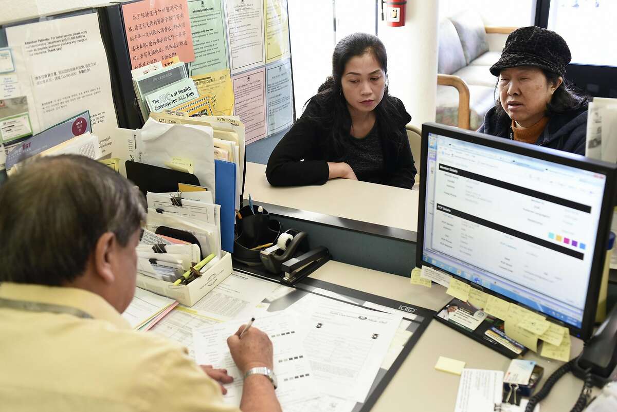 Customers Minh Nguyen, center, and her mother Mui Vong get help form Member services representative Wayee Thieu at the Asian Health Services offices on the final day of open enrollment for Covered California, the state's health insurance marketplace created by the Affordable Care Act, in Oakland, CA on Tuesday, January 31, 2017.