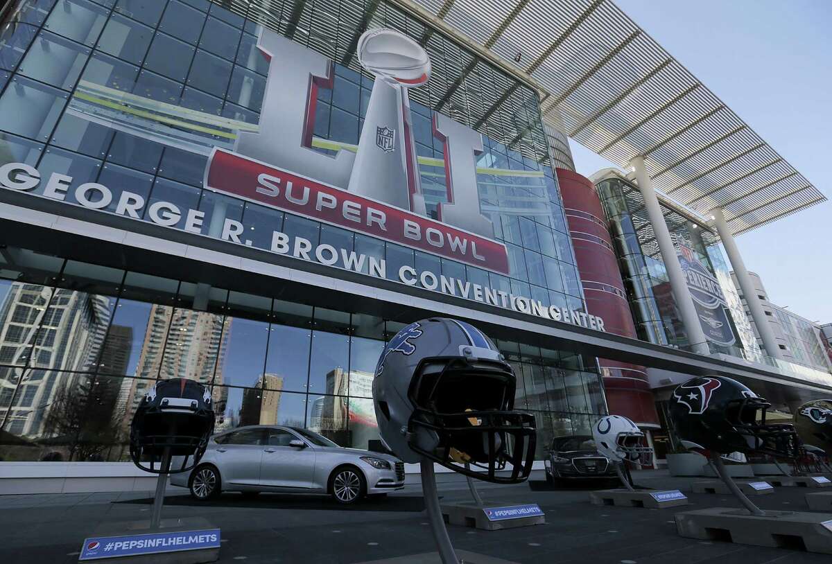 NFL helmets line the Avenida in front of the George R. Brown Convention Center in celebration of Super Bowl LI on Tuesday, Jan. 31, 2017, in Houston.