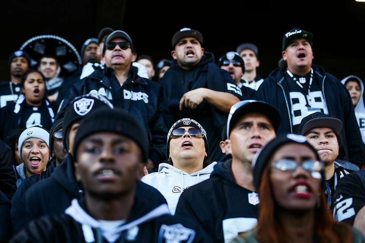 Raiders fans watch a game between the Oakland Raiders and the Indiana Colts in the fourth quarter, in Oakland, Calif., on Saturday, Dec. 24, 2016.