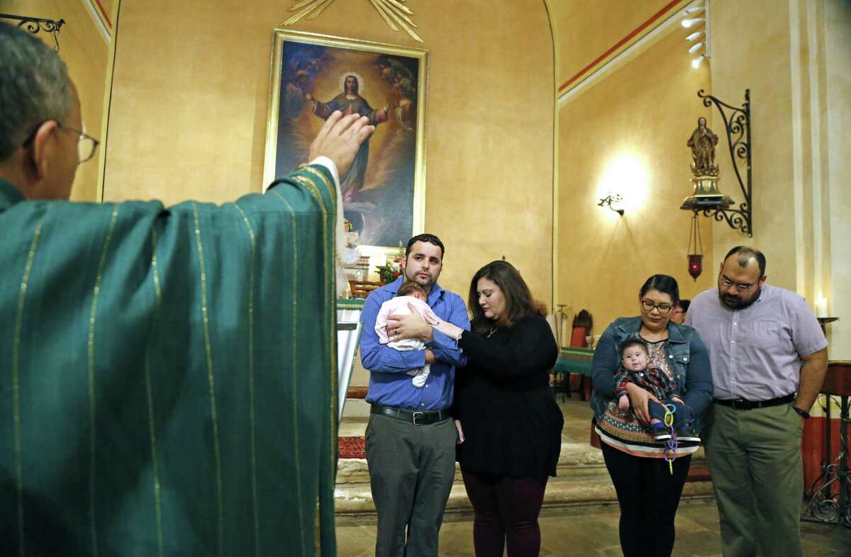 Father David Garcia blesses infants born in last 12 months at Mission Concepcion where the celebration of the "Levantada del Nino," a tradition that celebrates La Candelaria, the feast day of the presentation of the child Jesus at the temple. It's actually the last festivity of the Christmas season. Though the actual feast day is Feb. 2. Mission Concepcion will celebrate it Sunday. It's a longstanding tradition in the old parish, because of La Candelaria's significance to San Antonio. La Virgen de la Candelaria, the patroness of the Canary Islands, was the original name of the church that eventually became San Fernando Cathedral. on Sunday, January 29, 2017.