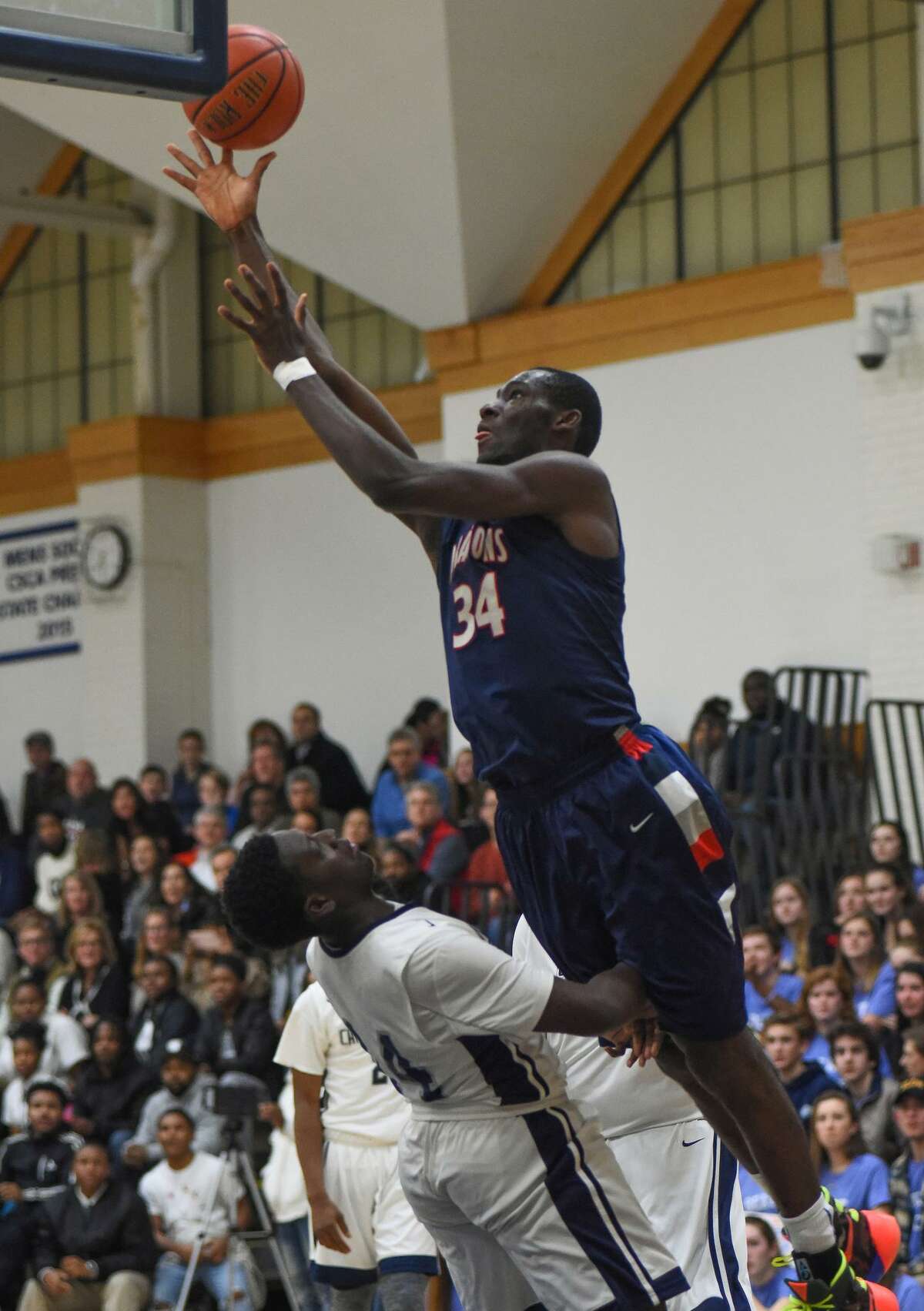 Greens Farms Academy's Sunday Okeke of Darien soars over an opponent from Capital Harbor Prep in the GFA's 87-74 victory at home Friday, Jan. 27. Okeke had 11 points on the night.