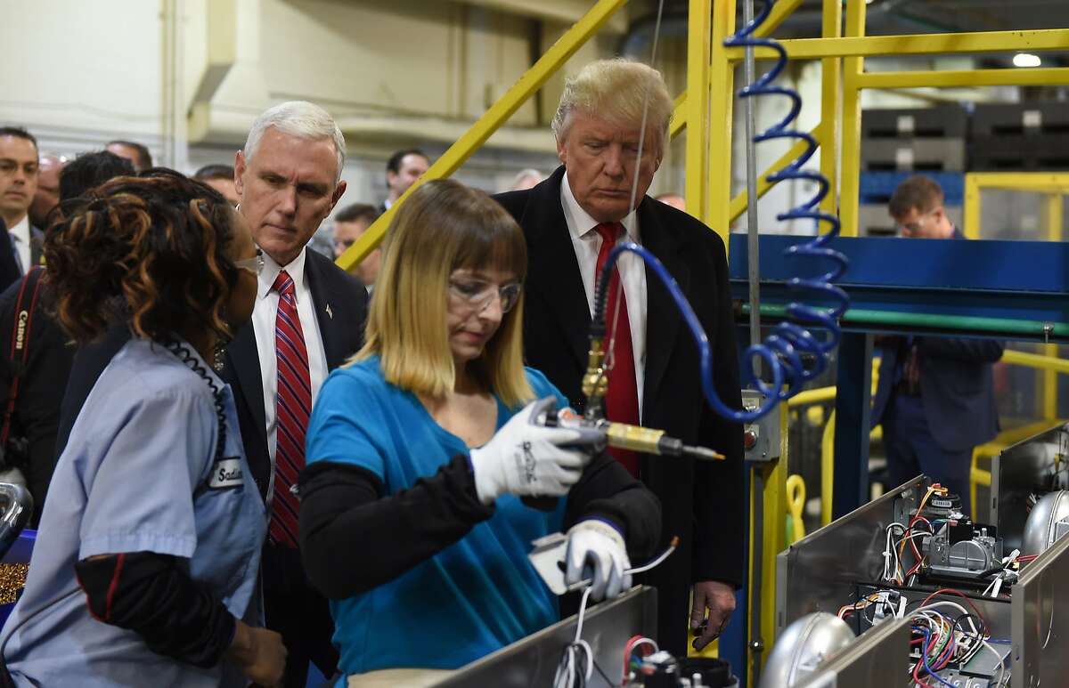 (FILES) This file photo taken on December 1, 2016 shows US President Donald Trump(R) and US Vice President-elect Governor Mike Pence during thier visit to the Carrier air conditioning and heating company in Indianapolis, Indiana. US manufacturing activity expanded in January for the fifth consecutive month as production, employment and prices all improved, and orders held steady, the Institute for Supply Management said on February 1, 2017. The ISM manufacturing index rose 1.5 points to 56 percent -- the highest since November 2014 -- with a strong majority of the industries surveyed reporting growth. / AFP PHOTO / TIMOTHY A. CLARYTIMOTHY A. CLARY/AFP/Getty Images