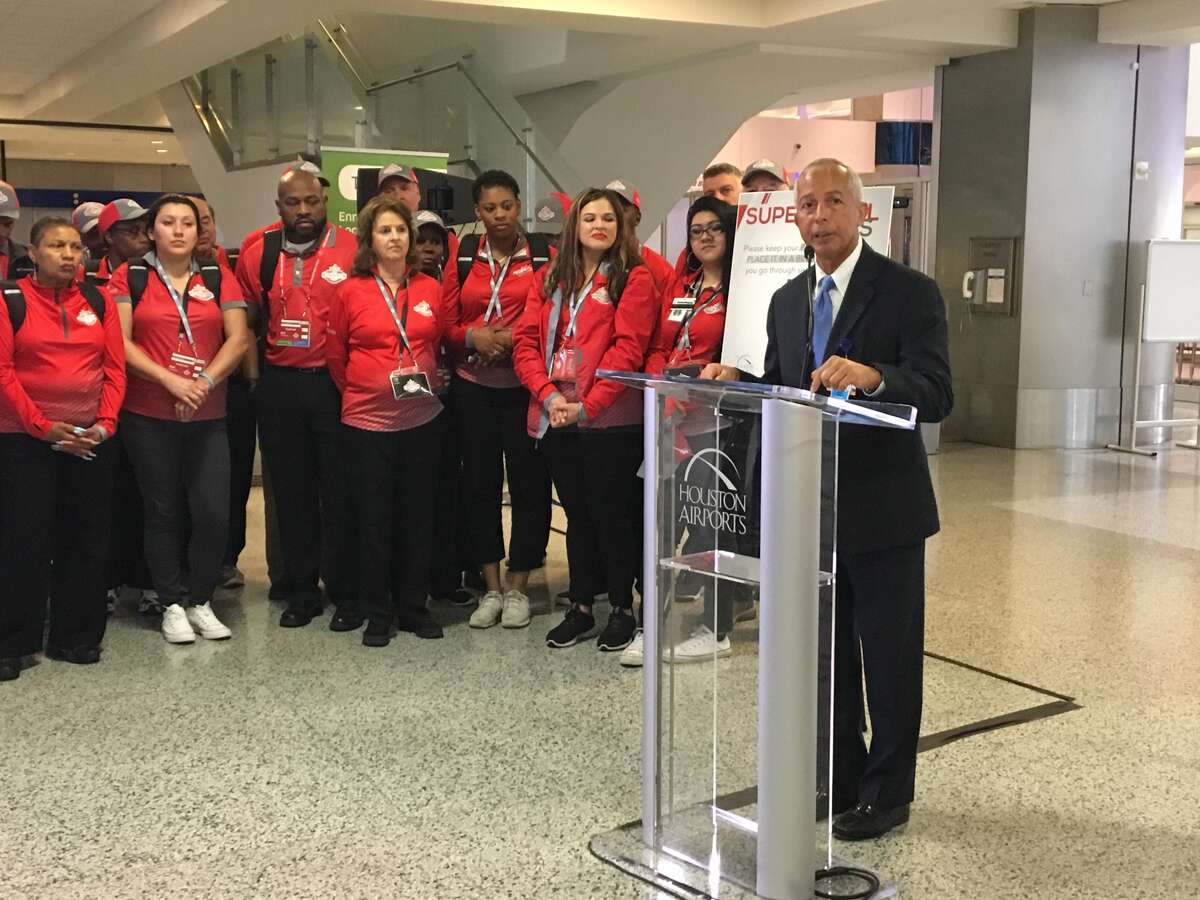 Mario Diaz, director of the Houston Airport System, is surrounded by volunteers who will provide Super Bowl information to people arriving at Bush Intercontinental Airport. The Houston Airport System held a media event Wednesday, Feb. 1, 2017, to discuss its preparations for the big game.