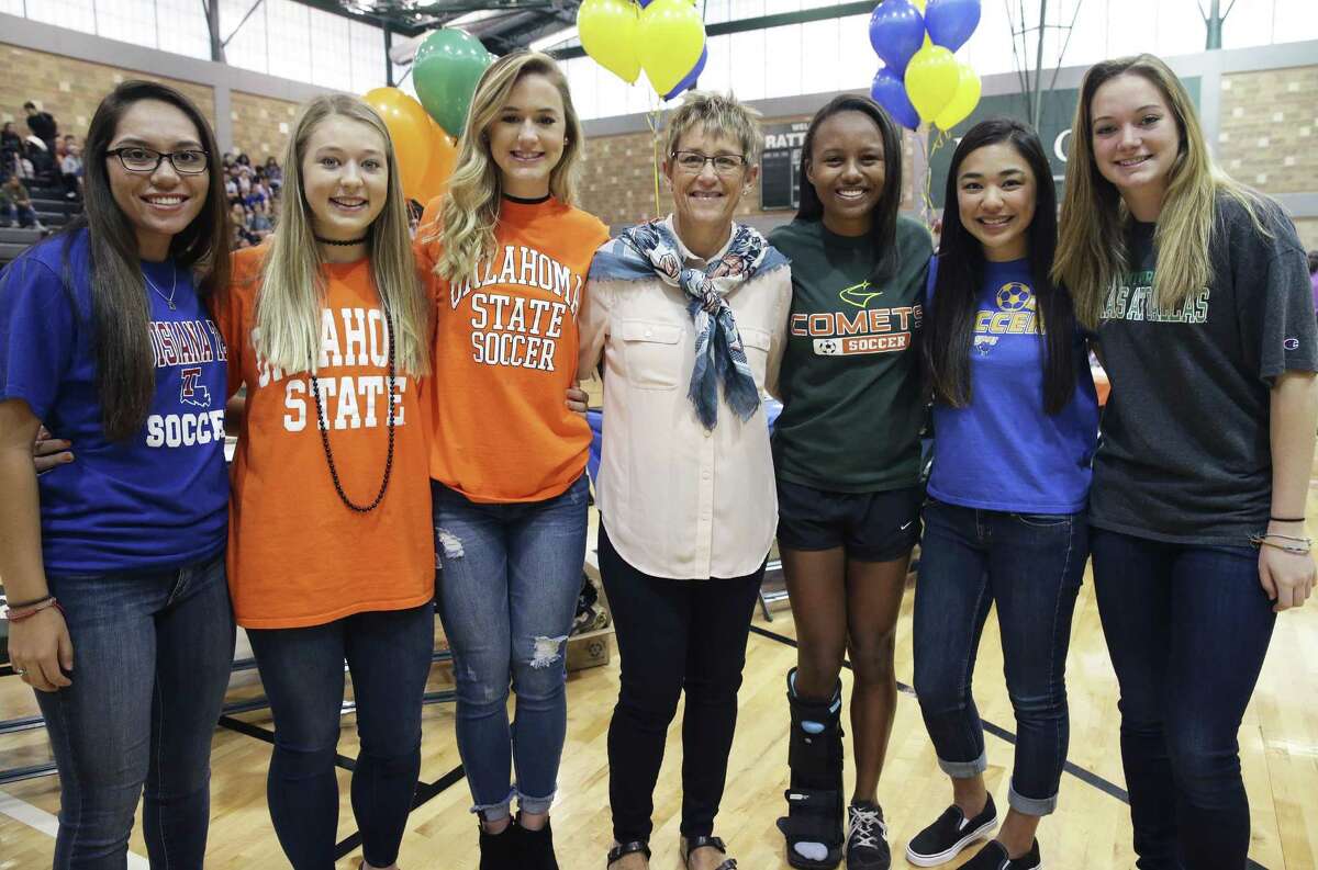 Scholarship soccer players stand with their coach Frankie Whitlock as Reagan High School athletes sign scholarship papers on national signing day, February 1, 2017. From left are Cori Hernandez (Louisiana Tech), Taylor Olson (Oklahoma State), Lauren Anderson (Oklahoma State), Whitlock, Jala Tousant (UT Dallas), Gaby Olsen (St. Mary’s) and Christa Morovitz (UT Dallas).