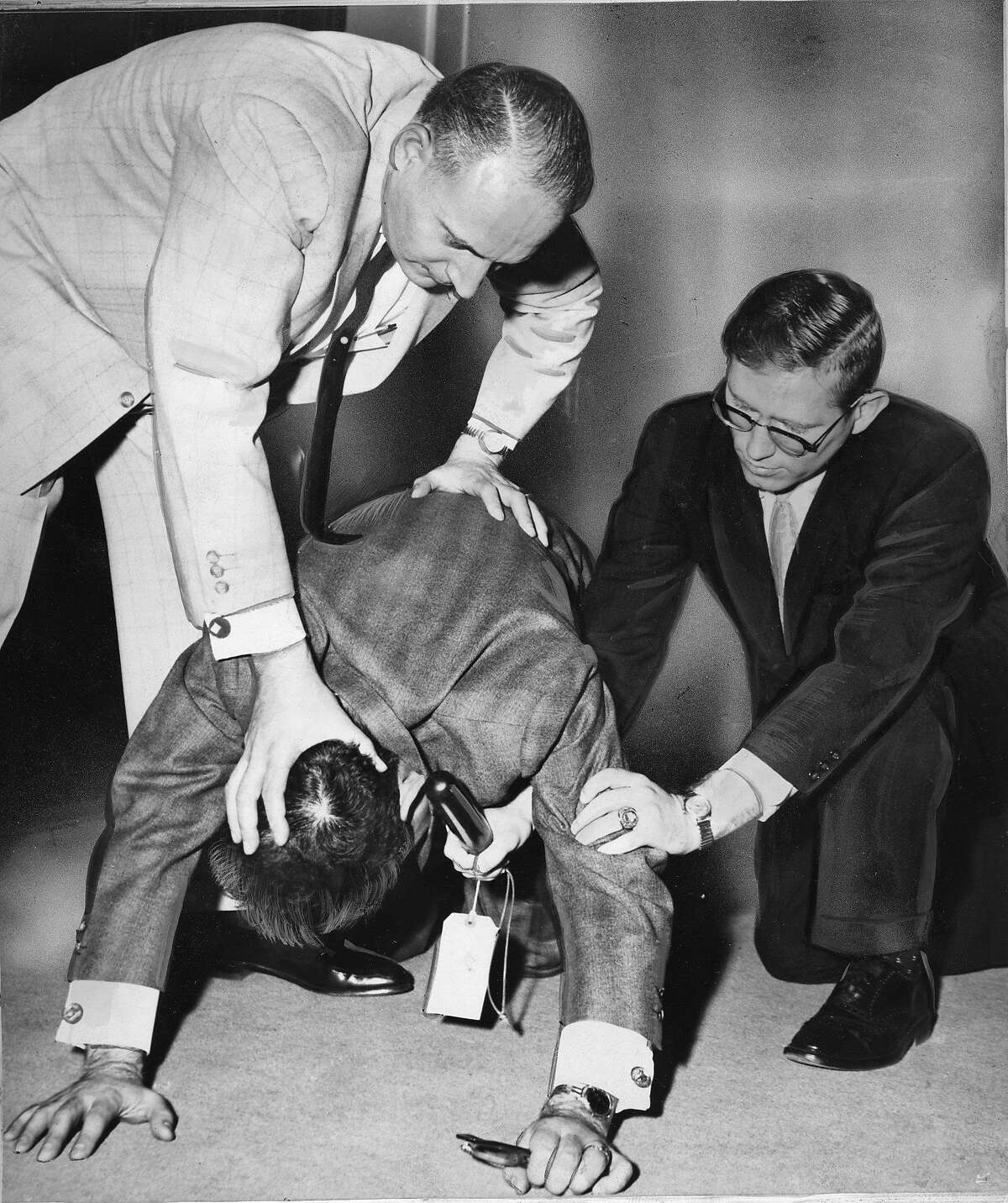 Robert Meisenbach, UC Berkeley student on trial for striking a police office at the HUAC protests at the San Francisco City Hall Here at the trial, his lawyers Charles Garry (top) and Jack Bernan bottom, demonstrate how Meisenbach was beaten photo ran 04/27/1961, P. 5