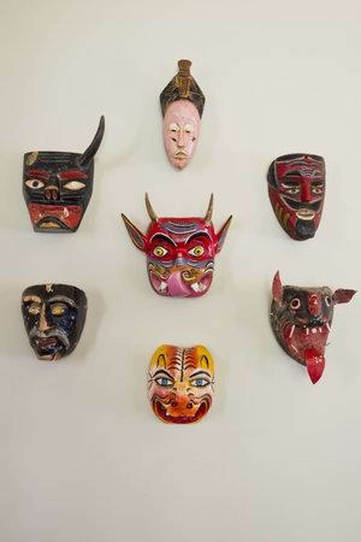 SCHONES: A wall of folk art masks in an El Prado Drive home by Whitney Schones.