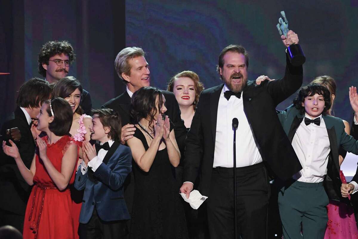 From left, actors Millie Bobby Brown, Natalia Dyer, John Paul Reynolds, Noah Schnapp, Winona Ryder, Matthew Modine, Shannon Purser, David Harbour, and Finn Wolfhard of 'Stranger Things' accept Outstanding Performance by an Ensemble in a Drama Series onstage during The 23rd Annual Screen Actors Guild Awards at The Shrine Auditorium Sunday. Many winners that night sounded alarms about the president’s travel and refugee ban.