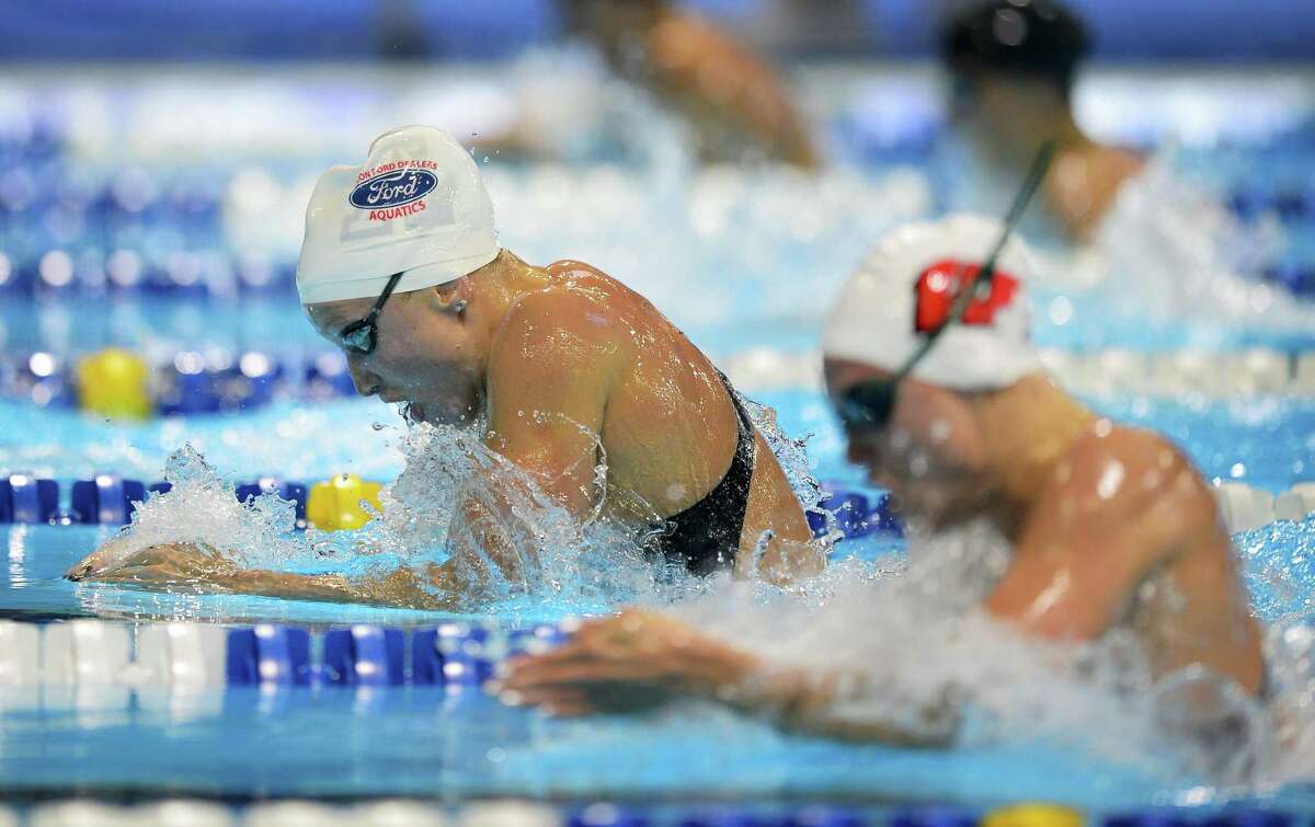 Annie Chandler (left) swims in the women’s 100-meter breaststroke preliminaries at the U.S. Olympic Swimming Trials, on June 26, 2012, in Omaha, Neb.