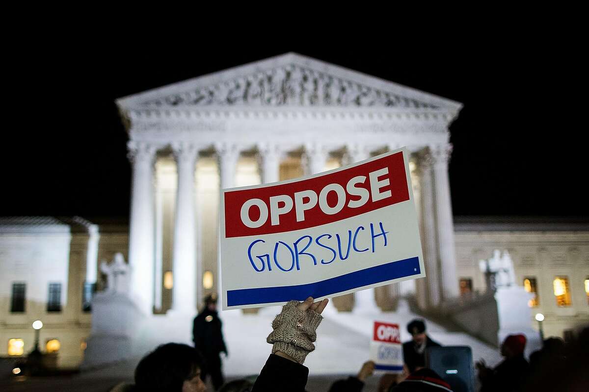 WASHINGTON, DC - JANUARY 31: Protestors gather outside of the Supreme Court, January 31, 2017 in Washington, DC. President Donald Trump announced on Tuesday night that he intends to nominate Neil Gorsuch to the Supreme Court. Gorsuch is a U.S. Circuit Judge of the U.S. Court of Appeals for the Tenth Circuit. If confirmed, Gorsuch will take the seat that has been vacant since the February 2016 death of Justice Antonin Scalia. (Photo by Drew Angerer/Getty Images)
