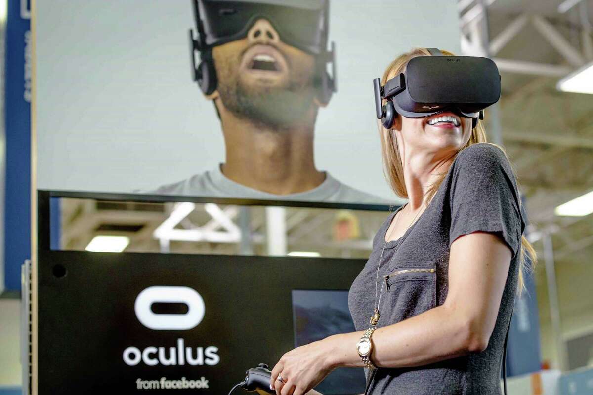 Facebook’s acquisition of Oculus gave it a head start against Microsoft Corp., Sony Corp., Alphabet Inc.’s Google and others competing for a piece of the virtual reality market that’s forecast to exceed $84 billion in sales in 2020. Facebook began shipping the ski-goggle-like Rift for $599 in March. Shown is a demonstration of Facebook’s Oculus Rift headsets.