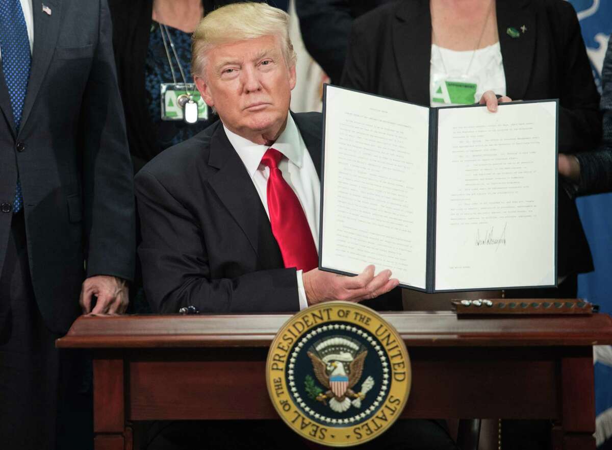 President Donald Trump displays an executive order to start the Mexico border wall project. The nation-state is back.