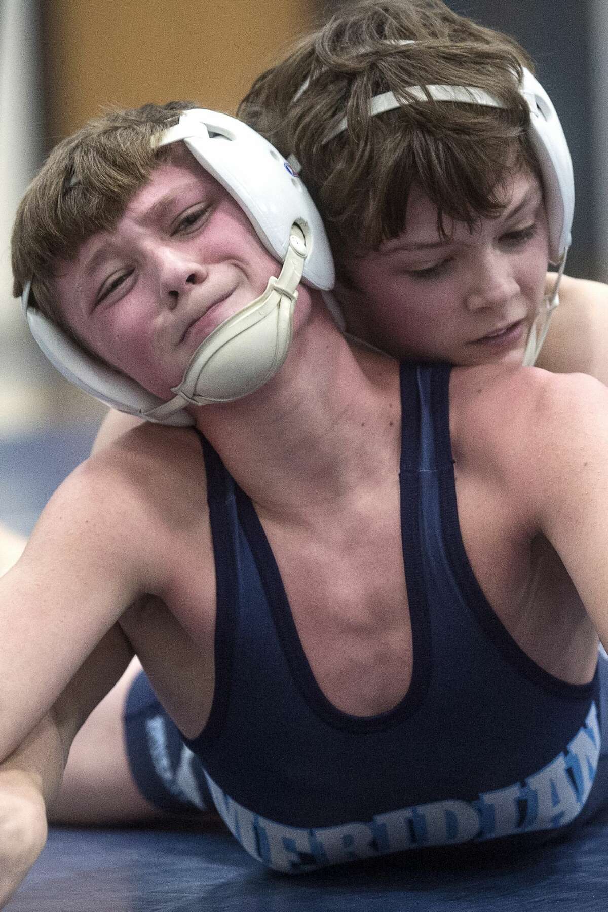 Meridian's Garret Mogg, left, wrestles with Chippewa Hills' Ozzie Manitou, right, in their 103-pound match on Wednesday at Meridian High School.