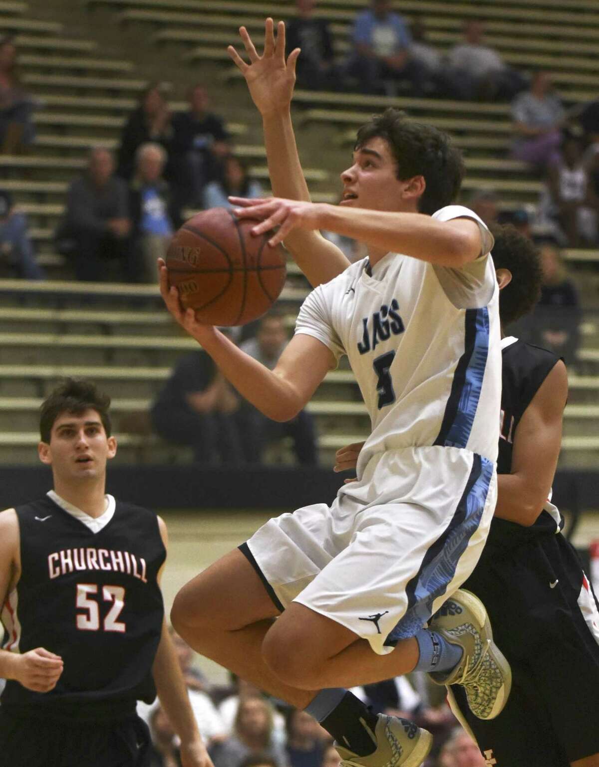 Johnson’s Cooper Walton lays up the ball during Wednesday’s game with Churchill.