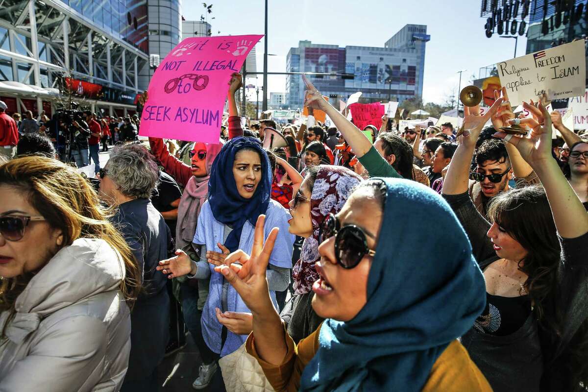 Maheen Virani (center) holds up a peace sign as she joins hundreds of people protesting Donald Trump's immigration orders outside Super Bowl Live on Sunday in Houston. The National Muslim Business says Houston boasts one of the largest Muslim populations in the South.