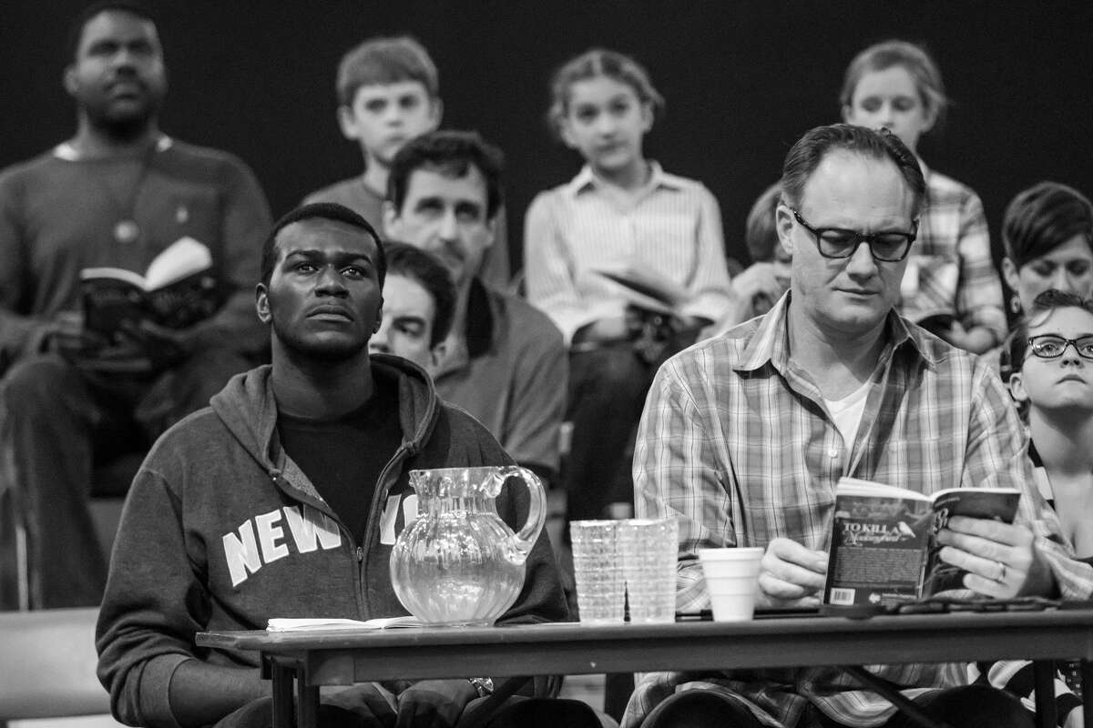 Seated at table, left to right are Andrew Carson (Tom Robinson) and Jason Douglas (Atticus Finch) in A.D. Players' "To Kill a Mockingbird." The play opens up the new Jeannette and L.M. George Theater (George Theater).