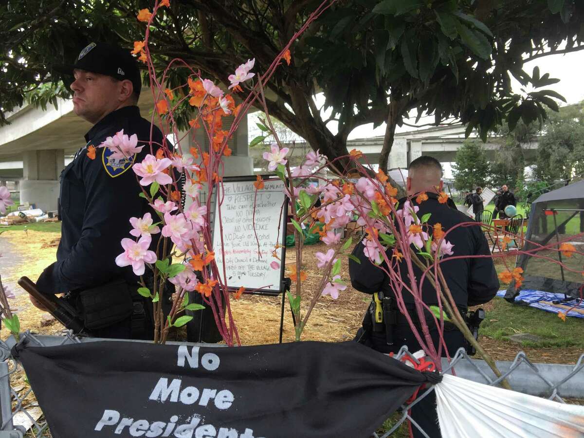 Oakland police officers told people in a homeless encampment at 36th Street and Martin Luther King Jr. Way on Thursday they had to leave the park.