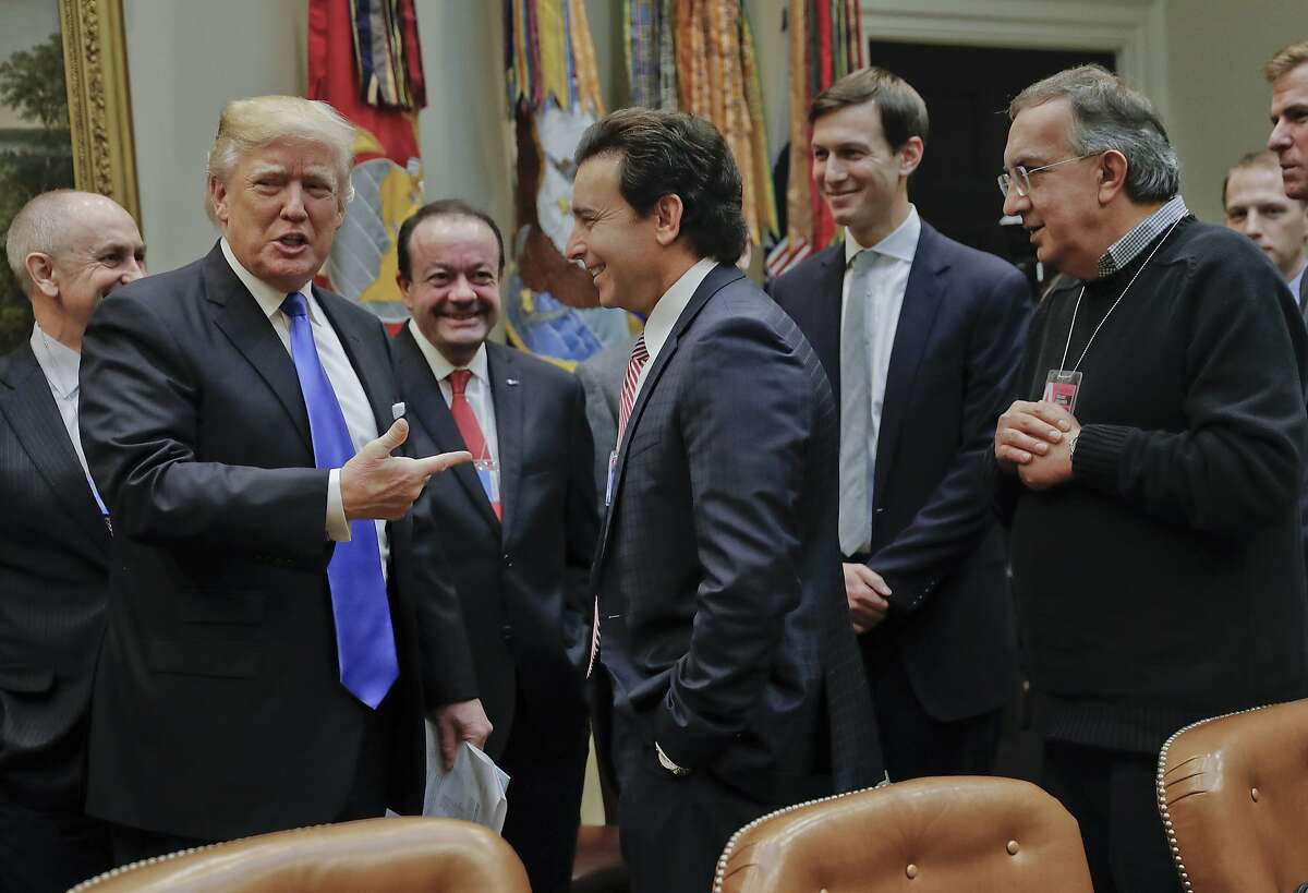 President Donald Trump points to Ford Motors CEO Mark Fields, center, at the start of a meeting with automobile leaders in the Roosevelt Room of the White House in Washington, Tuesday, Jan. 24, 2017. Also at the meeting are Fiat Chrysler Automobiles CEO Sergio Marchionne, right, and White House Senior Adviser Jared Kushner, second from the right. (AP Photo/Pablo Martinez Monsivais)